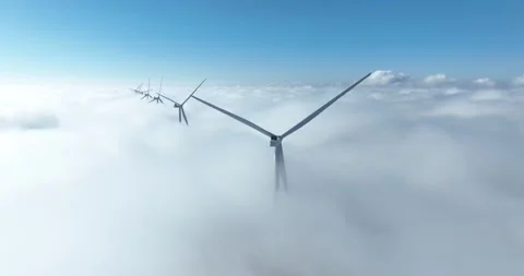 Wind turbines above the clouds, under blue sky. Aerial view. Видео 304816485
