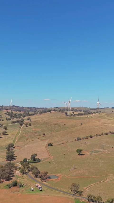 Wind turbines across rolling countryside hills in regional Australia Stock-Footage 335001653