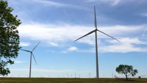 Wind turbines across a tree-framed rural Kansas landscape Stock Footage 347405209