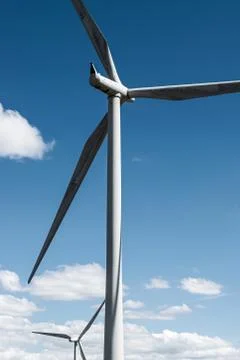 Wind turbines against blue sky. Stock Photos