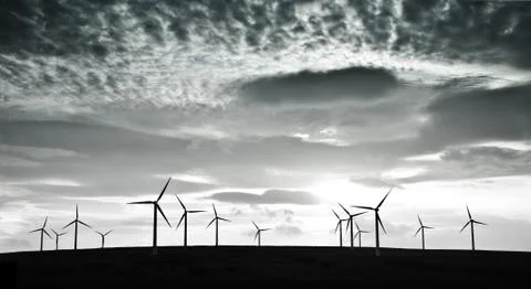 Wind turbines against dramatic clouds Stock Photos