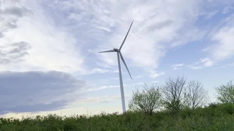 Wind Turbines on Agricultural Fields Under Dramatic Evening Sky Stockbeeldmateriaal 335215377