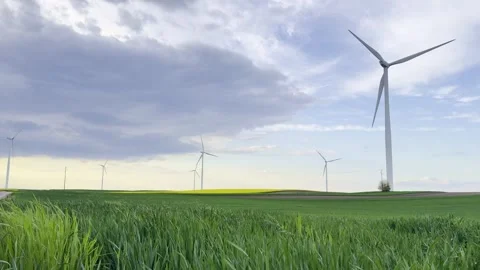 Wind Turbines on Agricultural Fields Under Dramatic Evening Sky Video stock 335215378