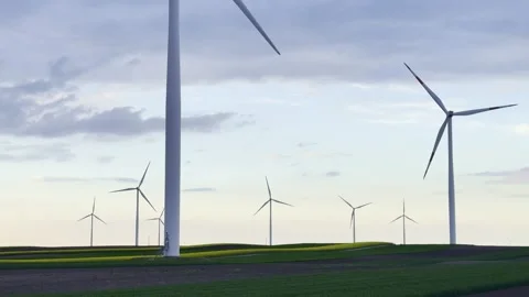 Wind Turbines on Agricultural Fields Under Dramatic Evening Sky Video stock 335215629