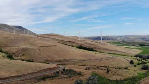 Wind turbines along a highway in eastern Washington's Columbia River Valley Stock Footage 109560867