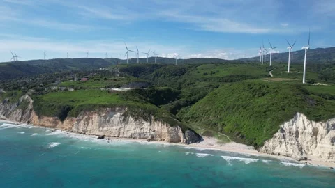 Wind turbines along white cliffs above a small beach, aerial view Stockbeeldmateriaal 278369540