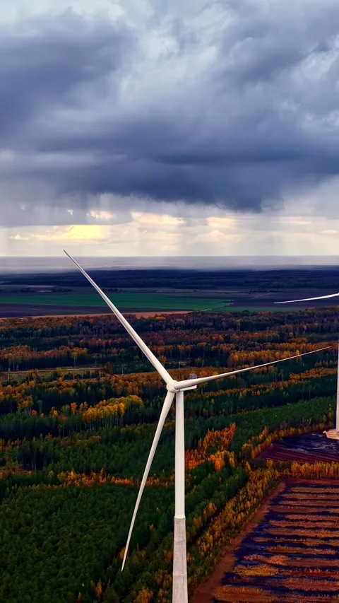 Wind Turbines Amidst Autumn Fields Under Dramatic Cloudy Skies Stock Footage 336662369