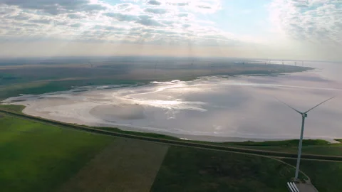 Wind turbines among green fields. Aerial view. Green energy concept. Video stock 158213474