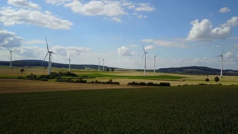 Wind turbines and maize fields farmland landscape drone shot sunny day Stock Footage 78553783