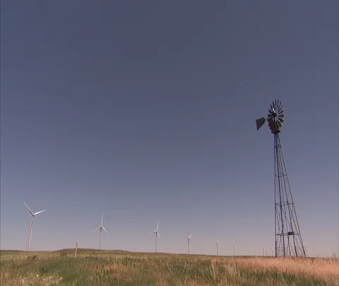 Wind turbines and old fashioned winmill in flat field. Stock Footage 86690909