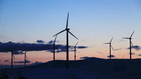 Wind Turbines and Snowy Fields at Dusk Stock Footage 324967993