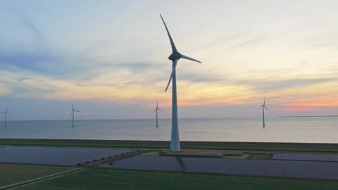 Wind turbines and solar panels generating sustainable energy at sunset Stock Footage 341876038