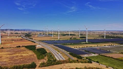 Wind turbines and solar panels on farmland in bright sunlight Vidéo 342605485
