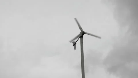 Wind turbines are spinning on cloudy sky background in rainy season.Green energy Stock Footage 139025440