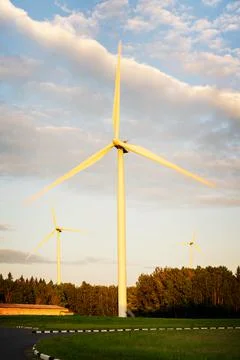 Wind turbines on beautiful sunny summer autumn forest landsape. Green ecological Stock Photos