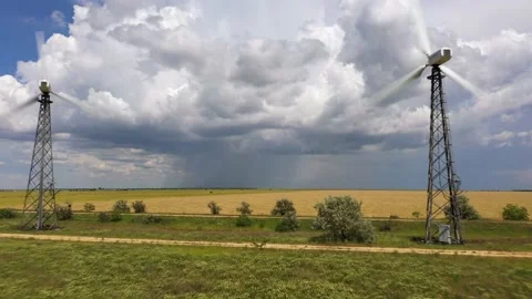 Wind turbines between the wheat fields against the cloudy thunder sky Stock Footage 165226213