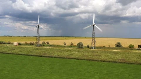 Wind turbines between the wheat fields against the cloudy thunder sky Stock Footage 165226219