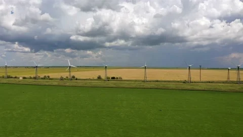 Wind turbines between the wheat fields against the cloudy thunder sky Stock Footage 165226258