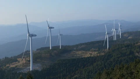 Wind Turbines Casting Shadows on a Mountain in a Morning (Realtime | Zoom Out) 스톡 동영상 236929920