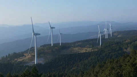 Wind Turbines Casting Shadows on a Mountain Forest in a Morning (Realtime) Stock-Footage 236930010