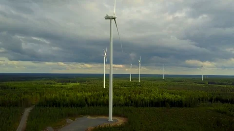 Wind turbines close-up on forest on cloudy day, 4K aerial video.  Stock Footage 78699778