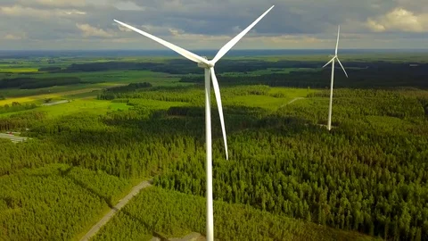 Wind turbines close-up on forest on cloudy day, aerial video.  Stock Footage 78699792