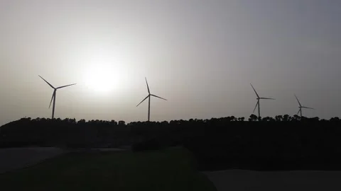 Wind turbines close view turning in dusty sunset atmosphere – clean energy Stock Footage 331284261
