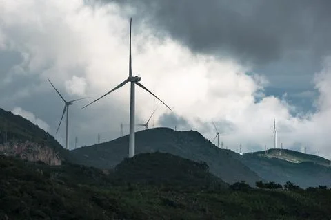 Wind turbines in the clouds on top of the mountain Stock Photos