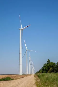 Wind turbines on cloudy blue sky background, Vertical Stock Photos