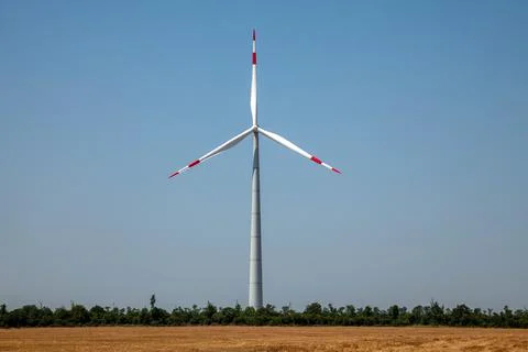 Wind turbines on cloudy blue sky background Stock Photos