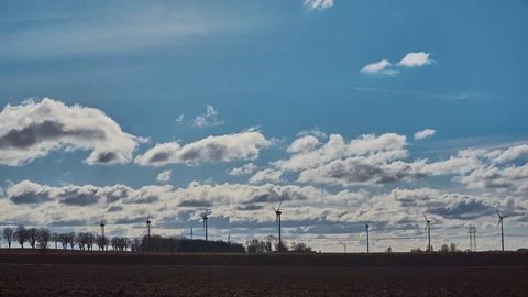 Wind turbines in a cloudy sky in timelapse 4k Stock Footage