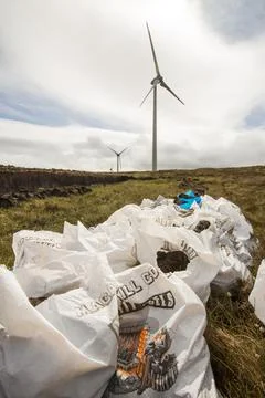 Wind turbines contrasting with peat cutting for fuel on the Isle of Lewis nea Stock Photos