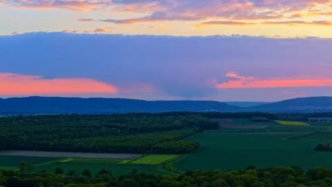 Wind Turbines at Dramatic Sunset Over Green Rural Landscape Stock-Fotos