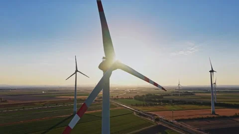 Wind turbines during sunset in an open field Video stock 342608783