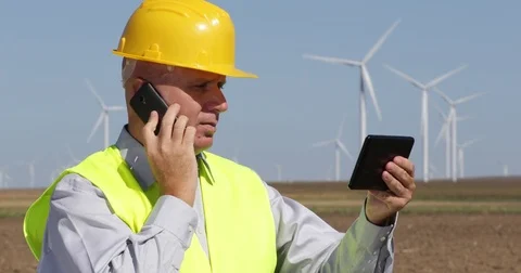 Wind Turbines Engineer Use Mobile Phone Touch Tablet Contact Maintenance Team Stock Footage 83658281