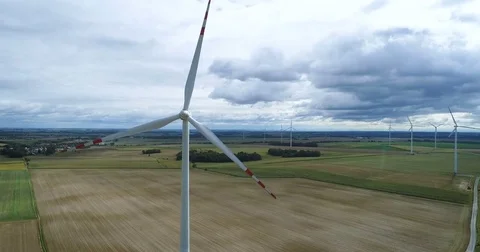 Wind turbines on the field during cloudy day Stock Footage 80249502