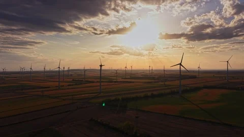 Wind turbines on a field during sunset with cloudy sky 库存影片 343122301