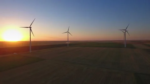 Wind turbines in a field at sunset Stock Footage 65585047
