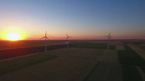 Wind turbines in a field at sunset Stock Footage 65631225