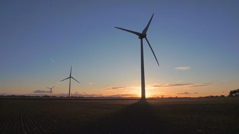 Wind turbines in a field at sunset Video stock 86387875