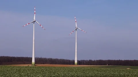 Wind turbines on fields in Austria Stock Footage 99890885