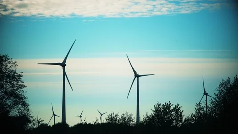Wind turbines in fields. Renewable energy. Dramatic color grading. Static shot Stock Footage 108778611