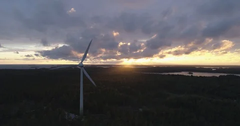 Wind Turbines in the Forest, Sun Breaks Through Clouds Video stock 86399329