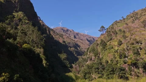 Wind turbines in forested mountain valley Madeira landscape Stock Footage 332842593