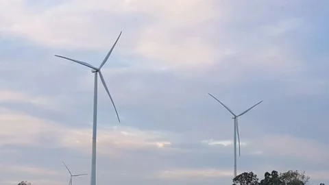 Wind turbines generate electricity from renewable energy for sustainable Stock Footage 229591372
