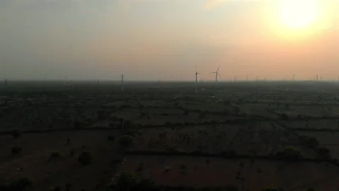 Wind turbines generate renewable energy at sunset Stock Footage 308161573