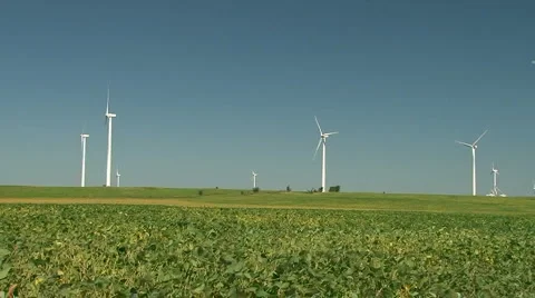 	Wind turbines generating clean electrical energy on agricultural farmland. Stock Footage 885968