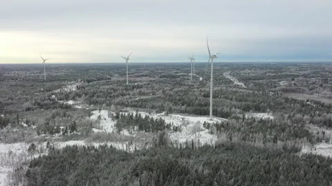 Wind turbines generating clean energy in snowy landscape, aerial view Stock Footage 289006482