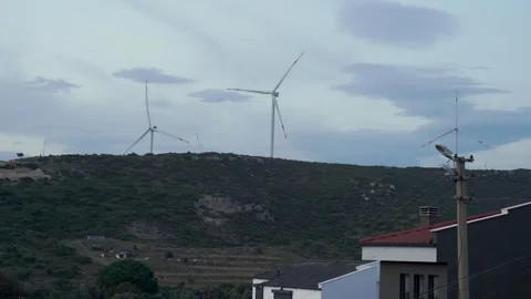 Wind Turbines Generating Clean Energy on Green Hillside in Rural Türkiye Stock Footage 323180102