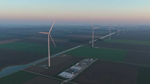 Wind turbines generating clean energy near battery storage facility Stock-Footage 331201428
